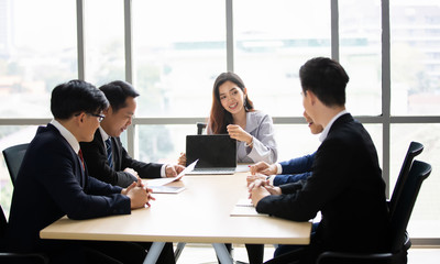 Business woman making a presentation at office. Business executive delivering a presentation to his colleagues during meeting or in-house business training, explaining business plans to his employees.