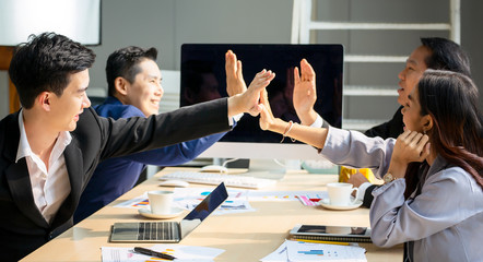 Business meeting, Young coworker team making great business discussion with computer in co-working office. Teamwork people concept.