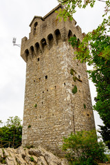 Fototapeta premium Montale Tower, the third tower of the City of San Marino, Republic of San Marino, low-angle view under overcast May sky