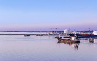 Fototapeta na wymiar Ship and boats at Marina in Ventspils at sunset