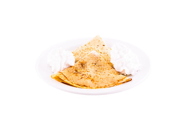 Pancakes with butter cream and nuts. Served on a white plate, melted on a white background. The photo is suitable for feeding mei restaurant. Dish of Montenegrin cuisine.