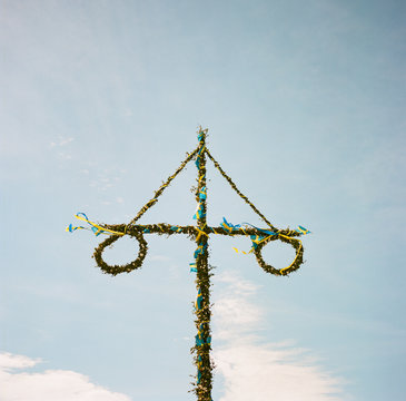 Swedish midsummer pole decorated with Swedish flags