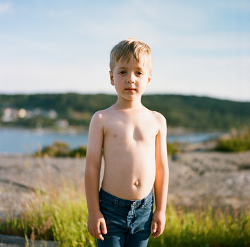 Portrait Of A Cute Boy In Jeans And No Shirt