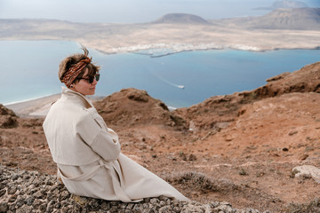 Back view of brunette woman enjoying of beautiful seascape.