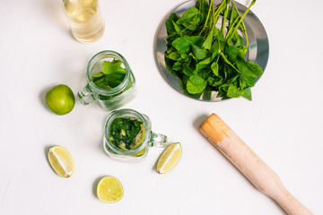 Mojito cocktail. The process of making an alcoholic summer cocktail. Lime, syrup and mint.
