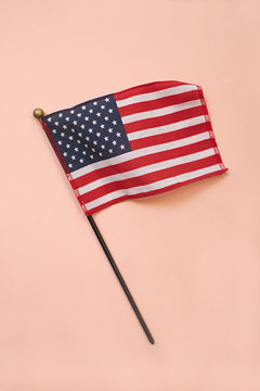Small American flag on a pink background