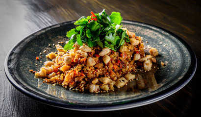 Fried rice with chicken and vegetables in plate on wooden table background