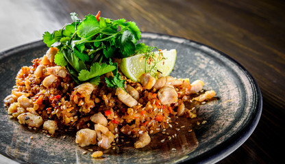 Fried rice with chicken and vegetables in plate on wooden table background