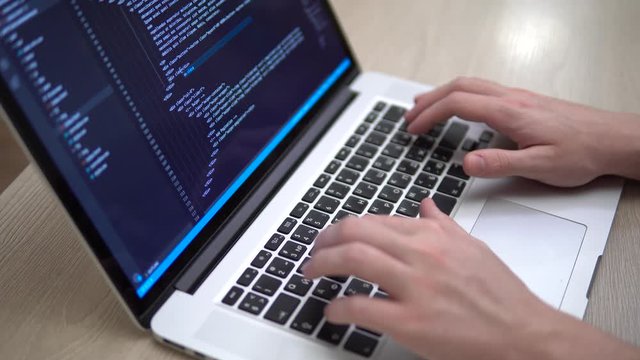 Coding on screen man hands coding html programming on screen laptop closeup