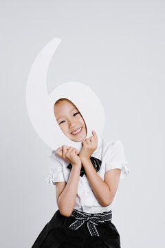 Portrait of 6 years old girl, with the number of 6