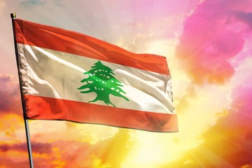 Fluttering Lebanon flag on beautiful colorful sunset or sunrise background. Success concept.