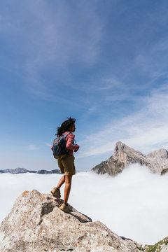 Young Woman Contemplating The Highest Point in Peaks of Europe above clouds