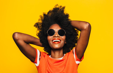 Happy Afro Woman posing over yellow background
