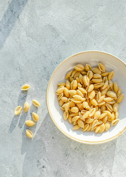 Fresh pasta shells in ceramic bowl