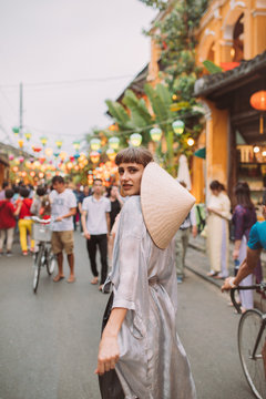 Woman in Vietnamese dress walking through the city of lanterns