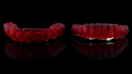 dental wax-up dentures with red wax crowns for the lower and upper jaws