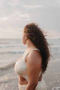 Side view of young woman standing on beach