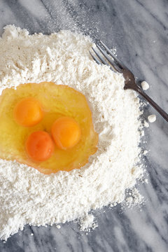 Eggs in a flour well for pasta making