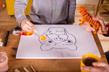 Boy painting with his father.