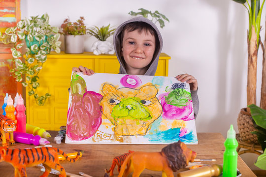 Boy showing his artwork at home.
