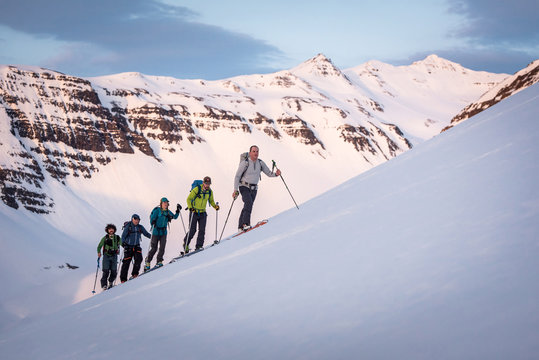 Group backcountry skiing in Iceland with mountains