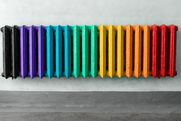 Vintage heating radiator made from cast iron. Colorful and hipster convector in room as a background for copy space