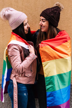 Lovely lesbian couple celebrating Pride Day. LGBT Concept.