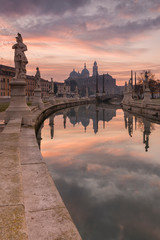 The magnificent statues of the Prato della Valle square during sunrise, Padova, Italy.