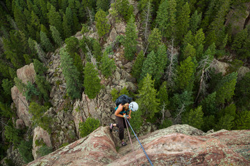 Woman rappels from summit of Matron, Flatirons near Boulder, Colorado