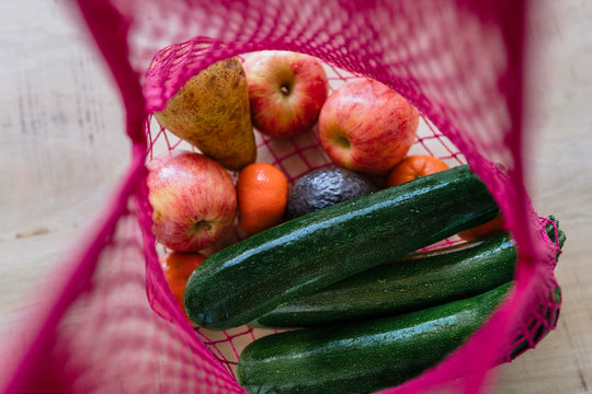 Eco friendly and reusable shopping mesh bag with fruits and vegetables