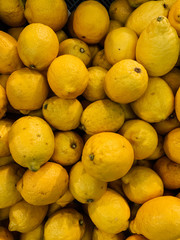 lots of delicious ripe yellow sour lemons to eat a background