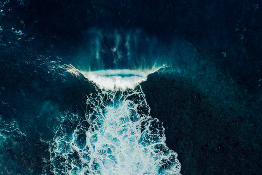 Aerial view of a perfect wave breaking over a lava reef in Tenerife