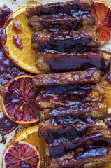 Vegan baked tempeh with bourbon marmelade glaze with orange slices