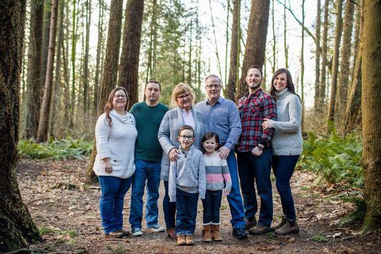 portrait of happy family of eight in the forest.