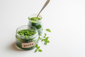 pesto sauce in a jar with a signed label on a white background - Powered by Adobe