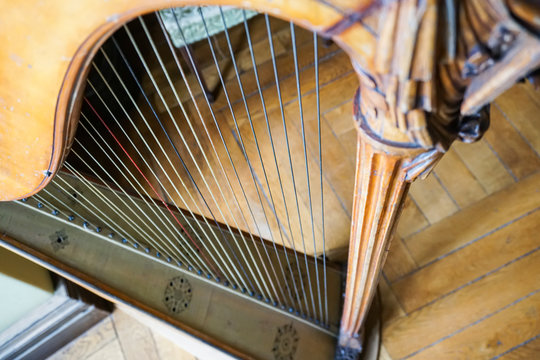 Part of musical instrument called harp in abstract background