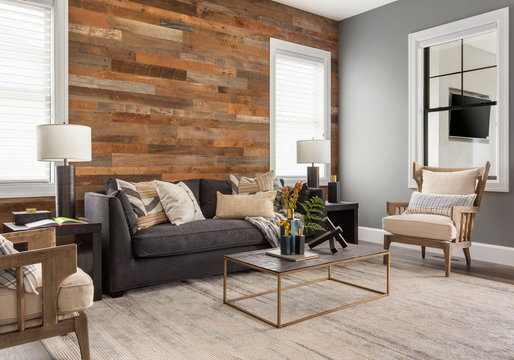 Beautiful living room in new luxury home with rustic accent wall.