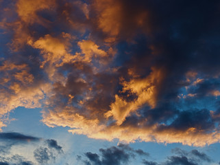 Obraz premium beautiful cloudy sky lit by the setting sun. Evening summer sky. Incredible sky.