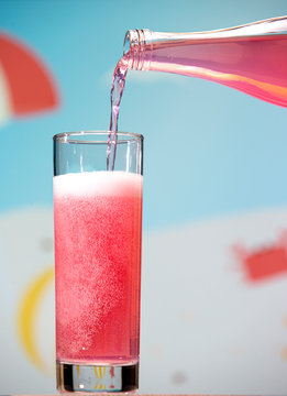 Guava Carbonated Drink Pours From A Bottle Into A Glass