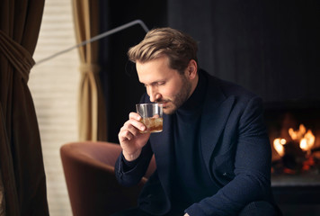 handsome man drinks a whisky