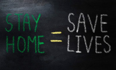 handwriting stay home means save lives on chalkboard 