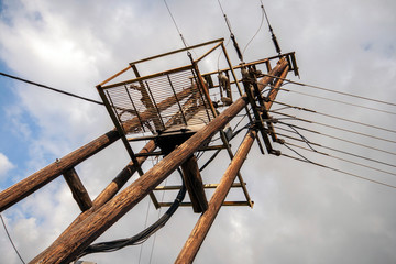 Fototapeta na wymiar Old power lines on a wooden pole