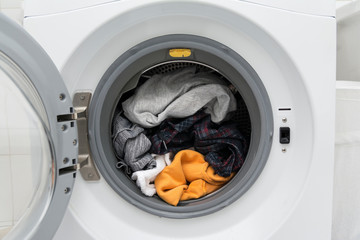 Close up of a washing machine full of clothes