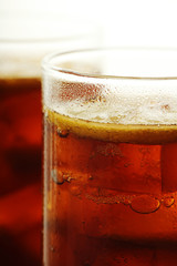 Glasses with cuba libre cocktail or cola with ice or cold tea with lemon