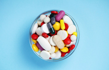 A bowl with colorful medicine pills	
