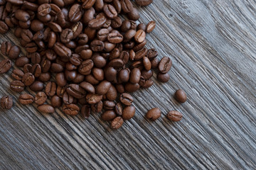 Coffee beans on a wooden table, top view.