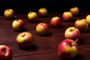 Fresh red-green apples on a wooden background.