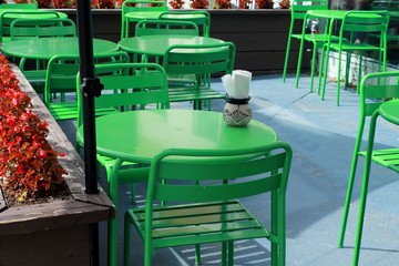 Sidewalk cafe terrace with empty chairs, concept of social distancing and nobody eating out during Covid-19 coronavirus outbreak and economy recession affecting small business during pandemic.