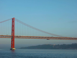 Fototapeta na wymiar Lisbon, Portugal-23 December 219: skyline, red bridge on 25 April crossing the river Tejo on a cloudy day at dusk.