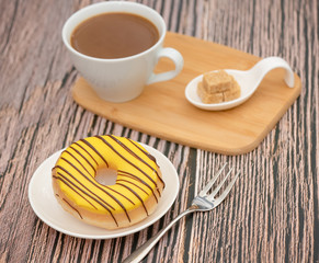 Dessert, Donuts, chocolate and strawberry circles, sugar and cream on Donuts and hot coffee cups, preparation for a break or party on the wooden table background.